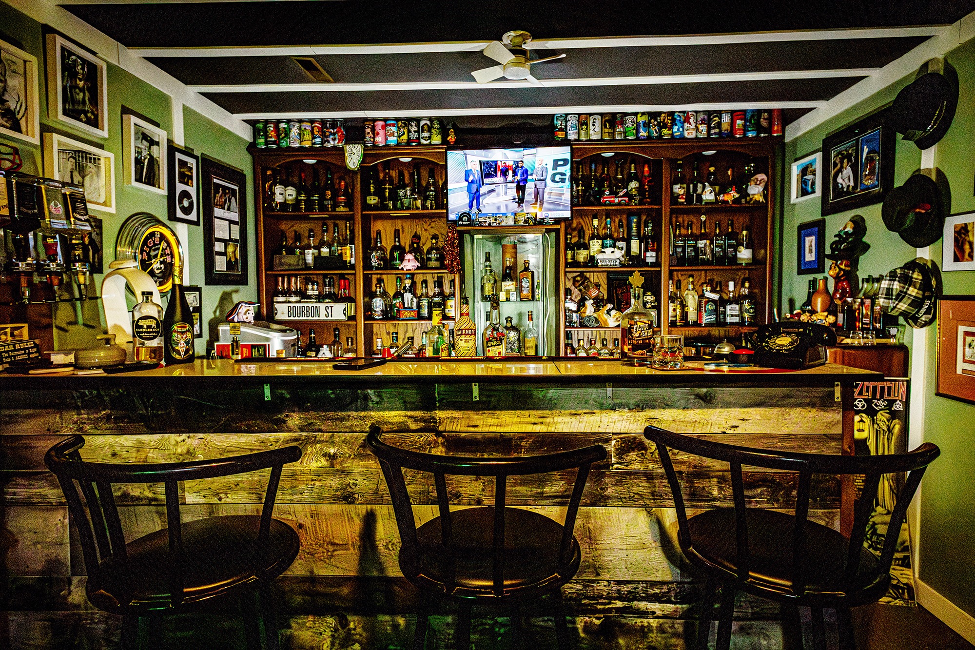 The Soaring Pig Bar – a home whiskey bar featuring an extensive collection of bourbon, scotch, and rare spirits, with rustic decor and personal memorabilia.